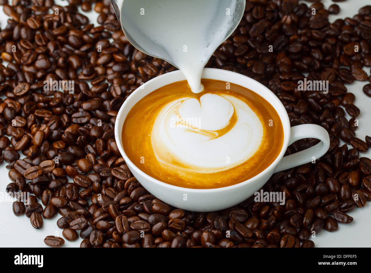 Latte art, coffee in coffee beans background Stock Photo