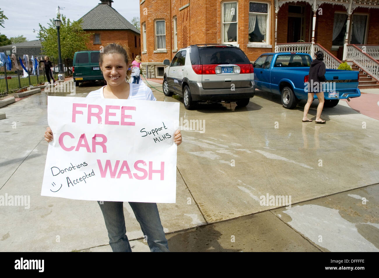 Group of teen volunteers hold a car wash to raise money for a project