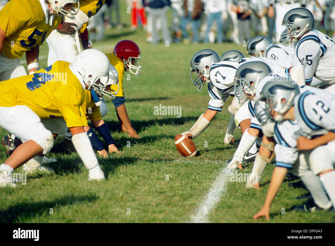 The line of scrimage of a junior varsity football game made up of 9th and 10th grade student Stock Photo