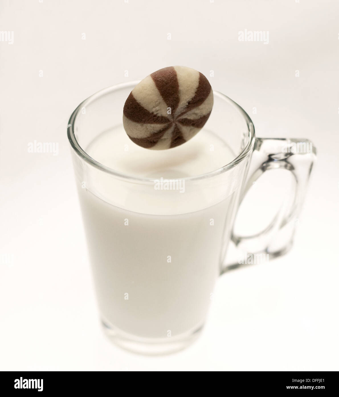 Chocolate Chip cookie dipped into a glass of Milk Stock Photo Alamy