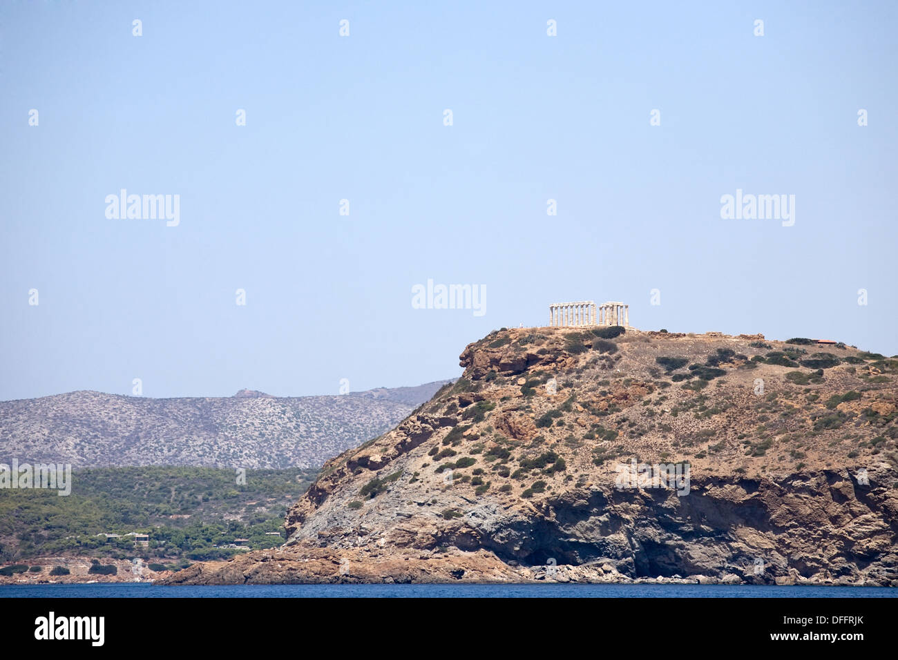 Poseidon temple on rocky cliff near Athens city, Greece, view from the sea Stock Photo