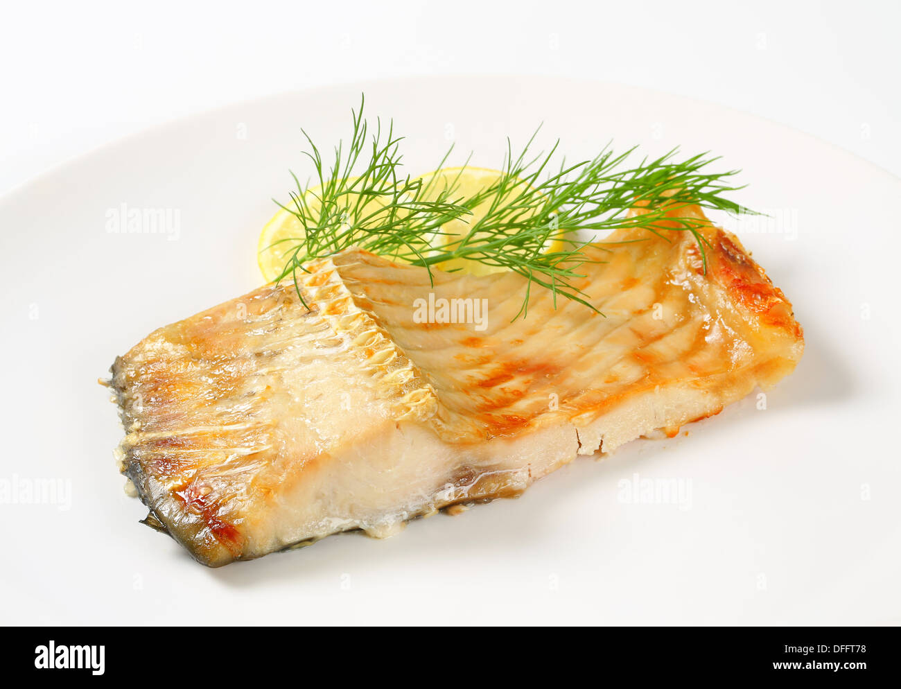 Oven baked carp fillet with lemon and dill Stock Photo