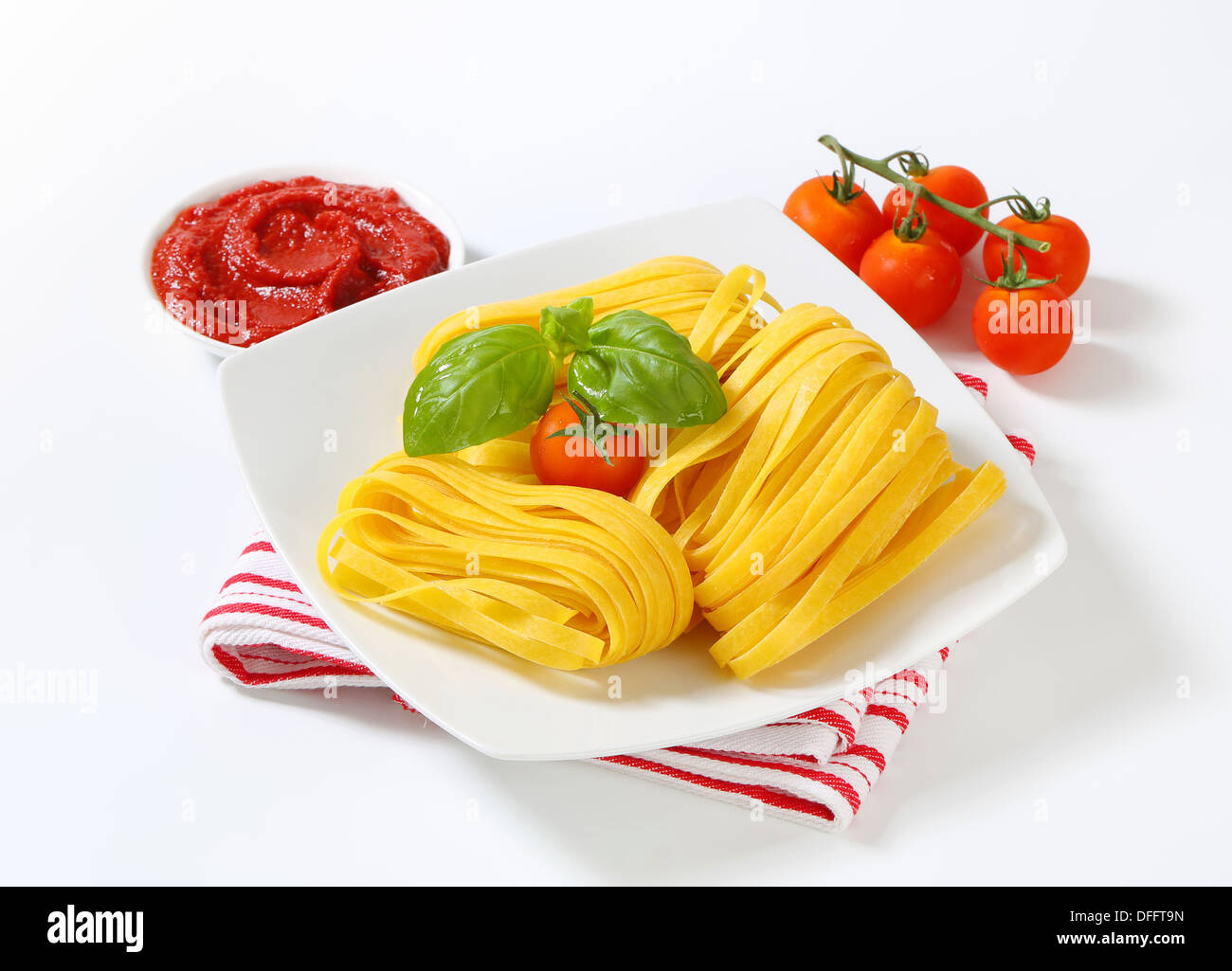 Thin ribbon pasta and tomato paste Stock Photo Alamy