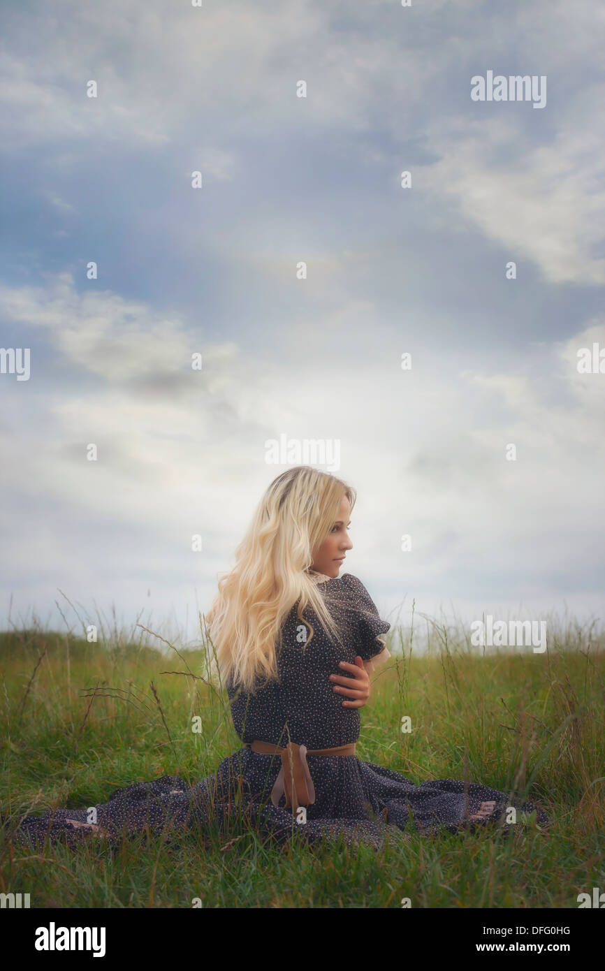 Sad girl sitting grass hi-res stock photography and images - Alamy