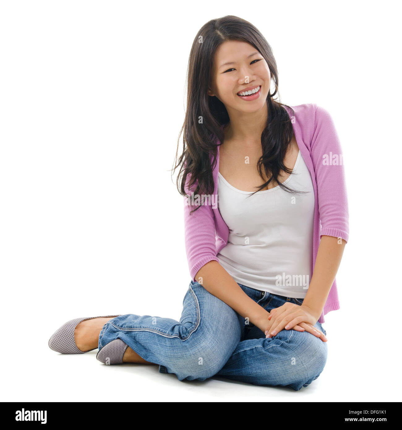 Portrait of Asian female smiling and sitting isolated over white background. Stock Photo