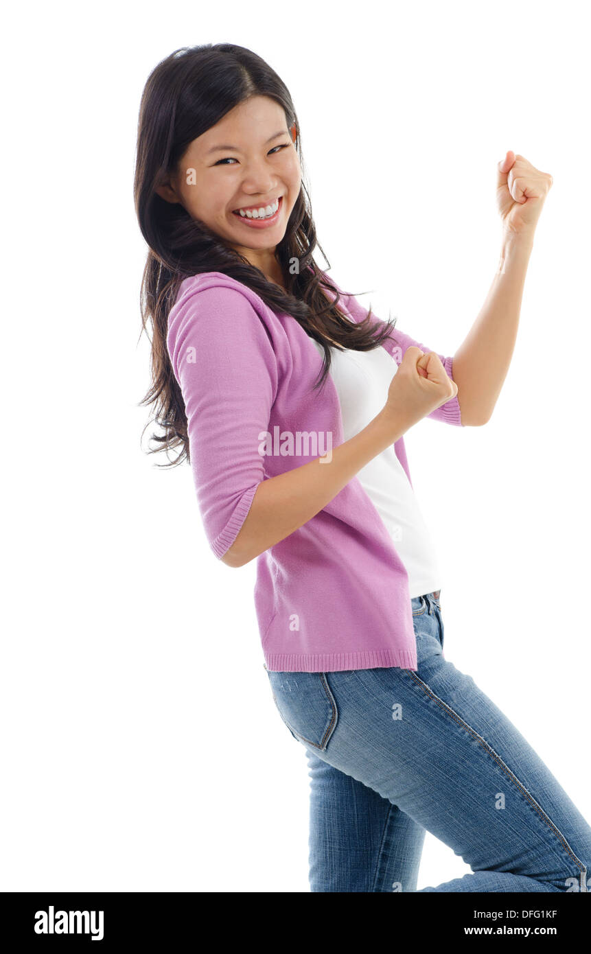Portrait of excited Asian woman celebrating success isolated over white ...