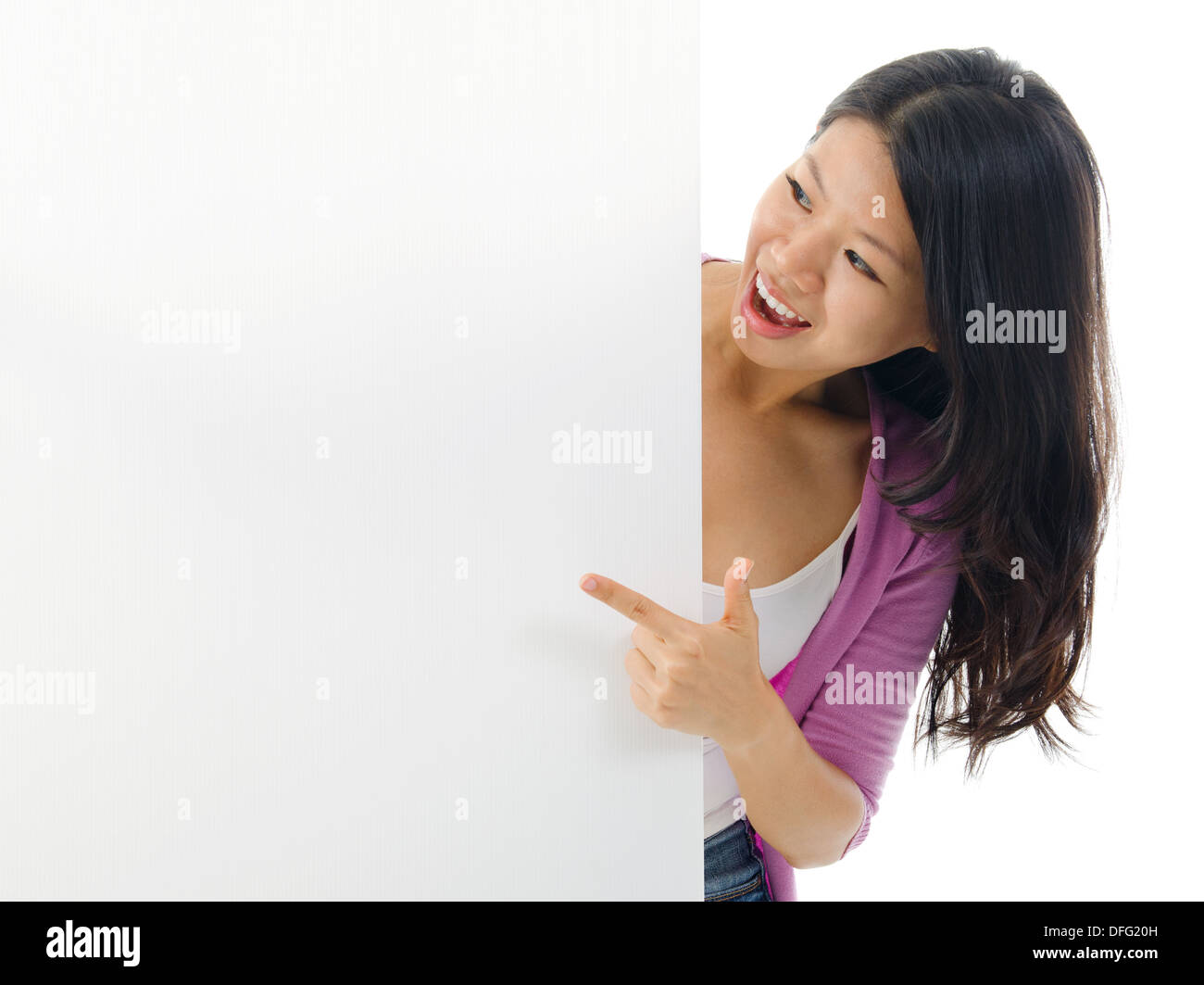 Asian woman holding and pointing to blank billboard portrait of young