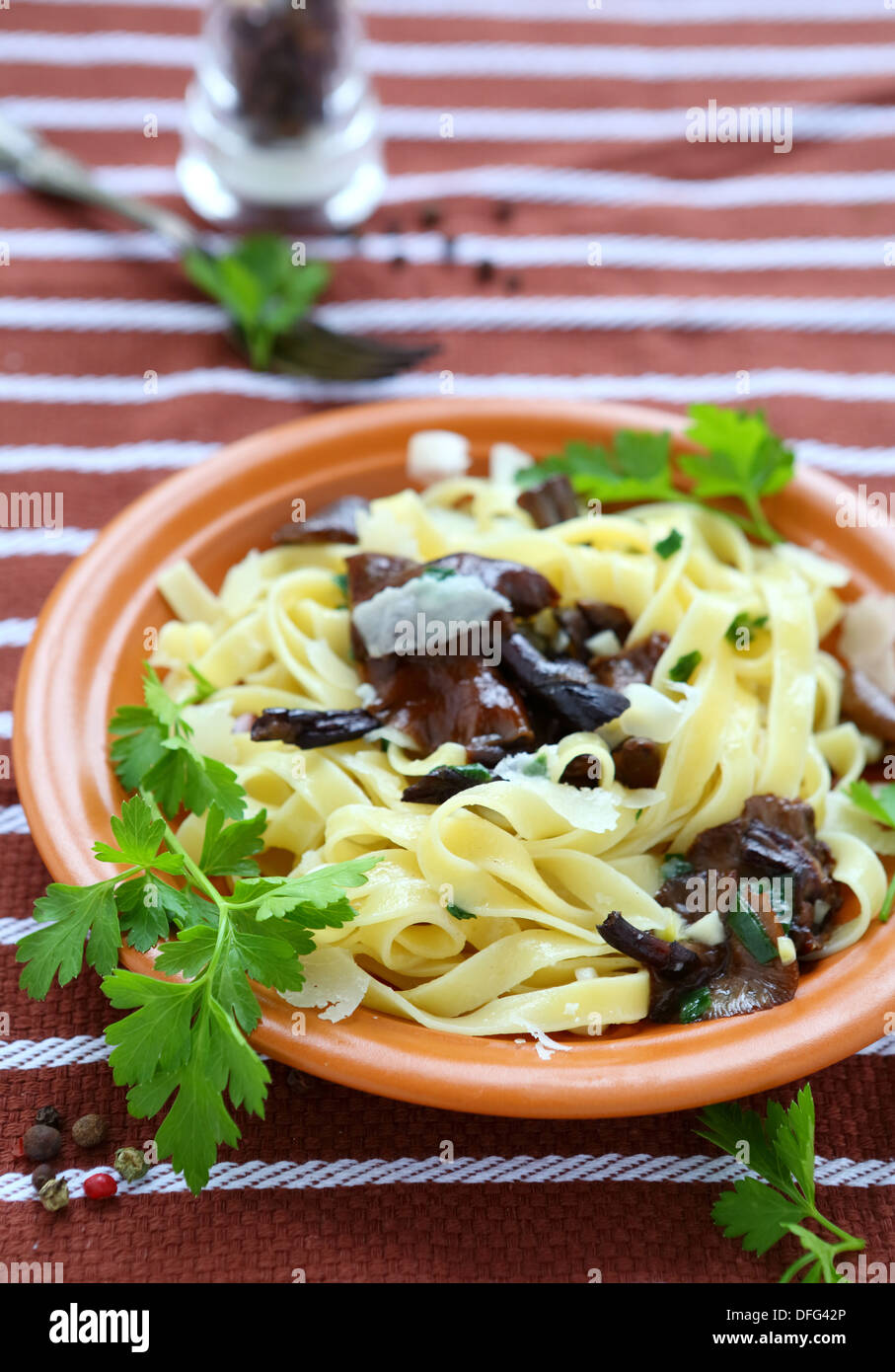Tagliatelle pasta with mushrooms and parmesan cheese, food closeup Stock Photo