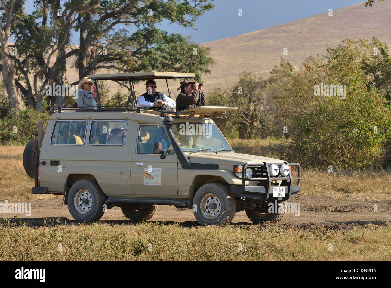 Safari vehicle travelling in the Ngorongoro Crater, Ngorongoro Conservation Area, Tanzania Stock Photo