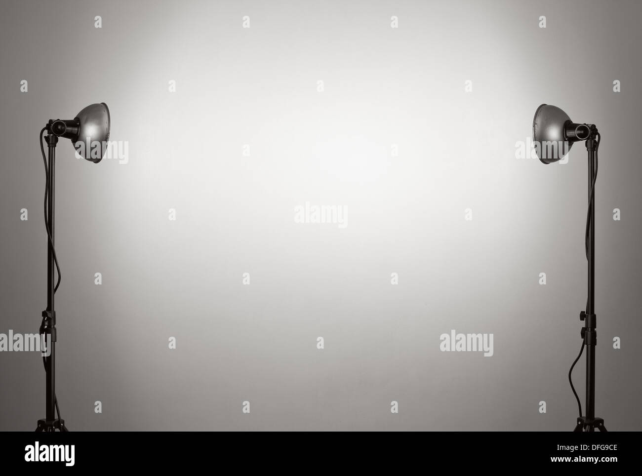 Old lamps on a stands against empty wall. Stock Photo