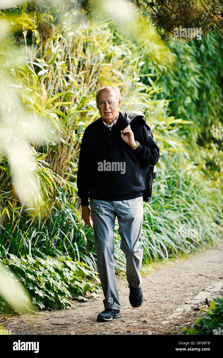 Typical pensioner in a park in autumn. Stock Photo