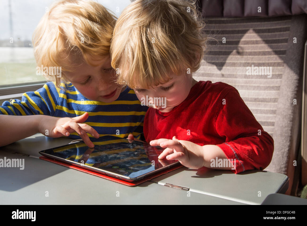 Two Brothers playing on an iPad Stock Photo