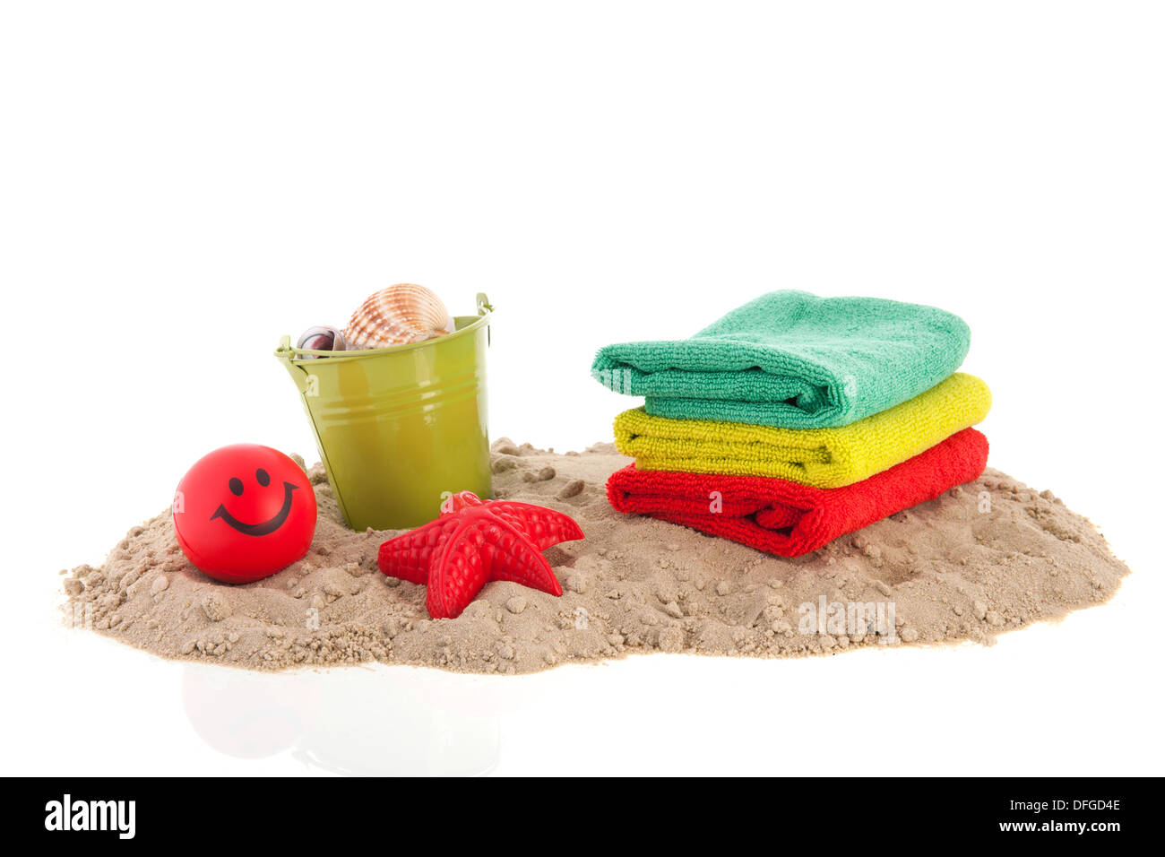 Sand at the beach with towels and toys Stock Photo