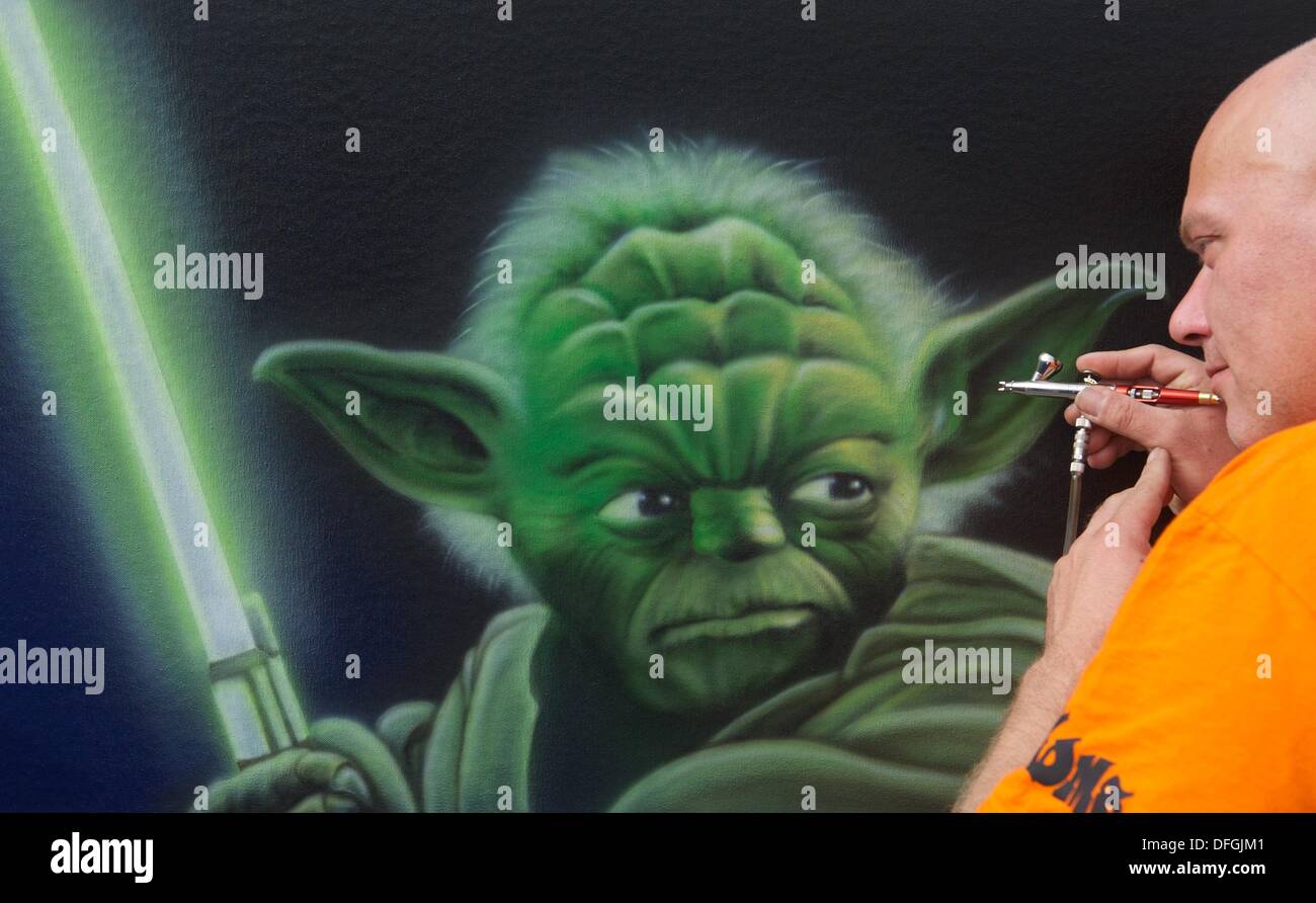 Leipzig, Germany. 01st Oct, 2013. A man sprays a 'Yoda' figure from 'Star Wars - The Clone Wars' with an airbrush at the expo Modell-Hobby-Spiel in Leipzig, Germany, 01 October 2013. The expo starts on 03 October 2013 and run for four days with 650 exhibitors. Photo: Peter Endig/dpa/Alamy Live News Stock Photo