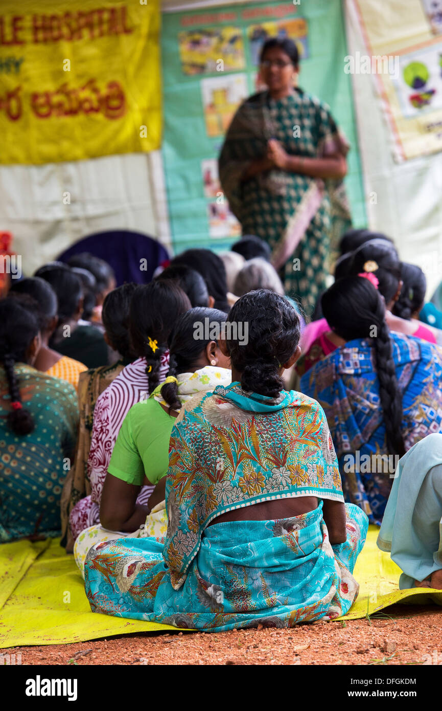 Rural Indian women receiving health advise in a waiting area at Sri Sathya Sai Baba mobile outreach hospital service clinic. Andhra Pradesh, India Stock Photo