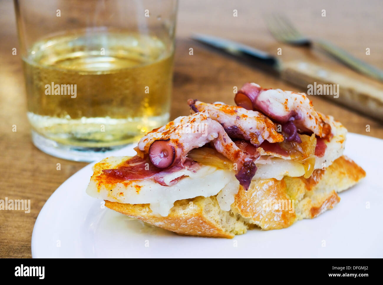 Typical spanish octopus pincho (Galician octopus style) in rustic table Stock Photo