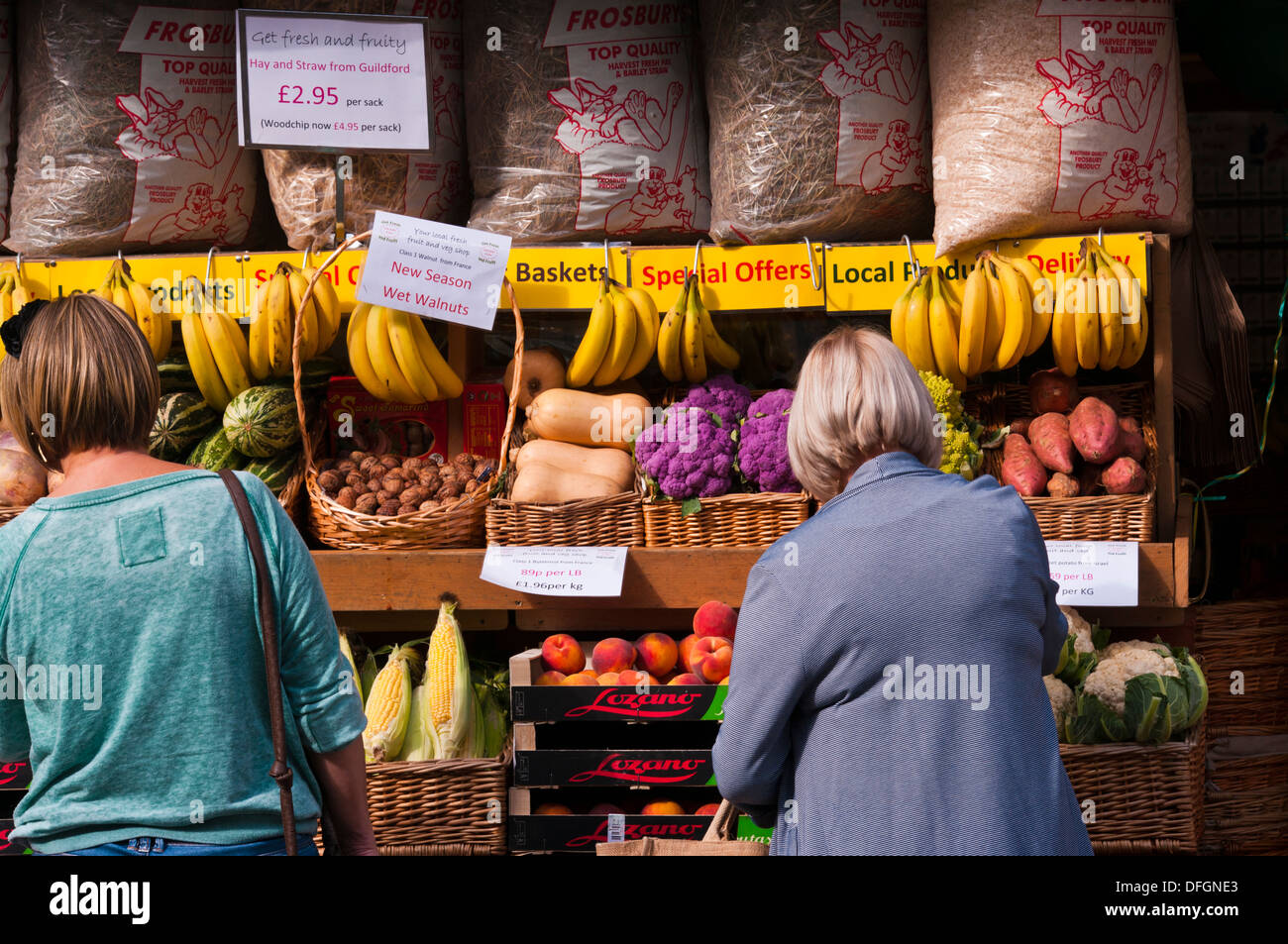 Women Browsing Outside A greengrocers Fruit and Veg Shop Display UK Stock Photo