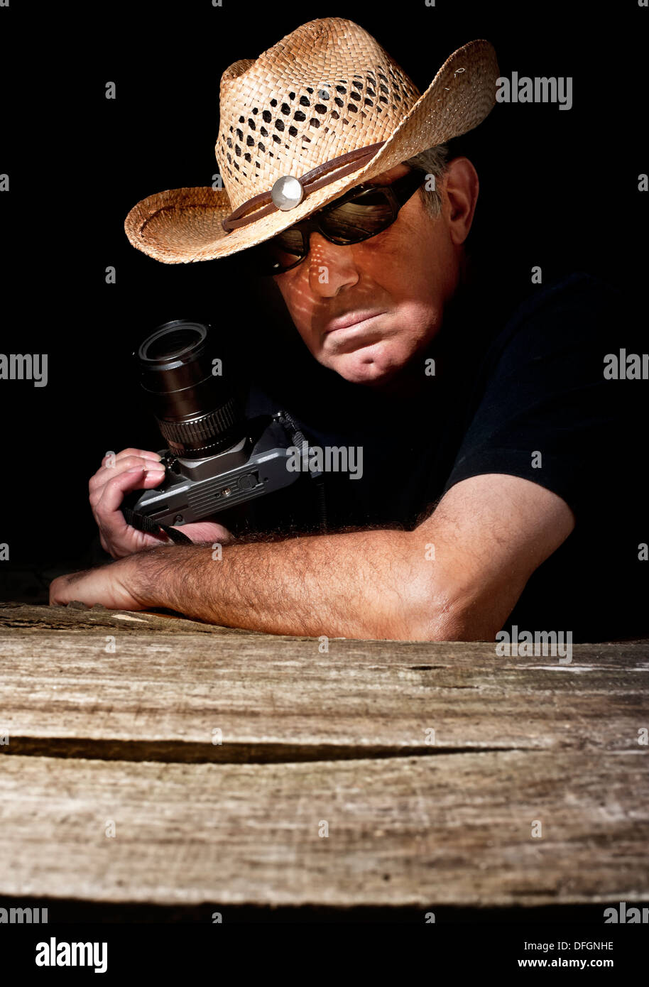Paparazzi with cowboy hat in black background Stock Photo