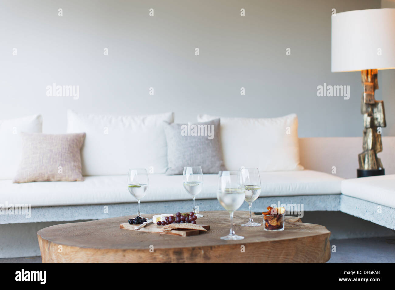 Wine and cheese on coffee table in modern living room Stock Photo