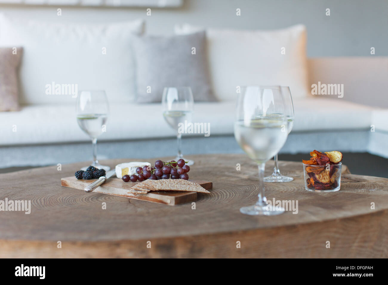 Wine and cheese on wooden coffee table Stock Photo