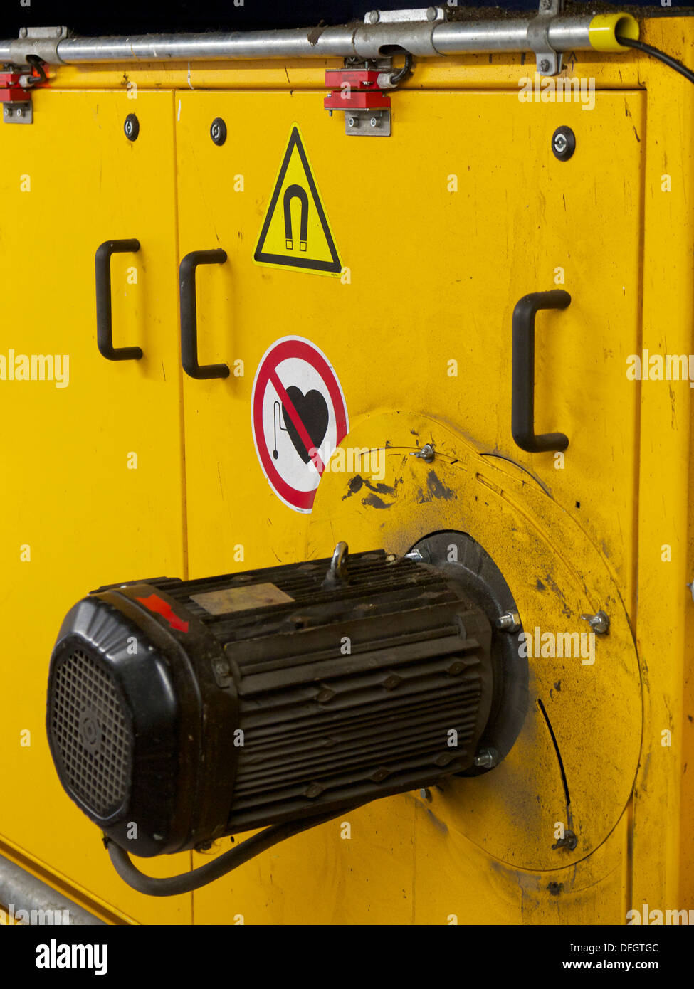Warning on the side of a machine with strong magnetic fields for people with a pacemaker. Stock Photo