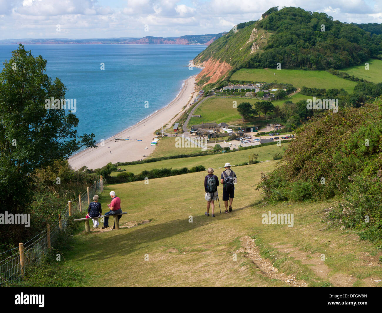 Walkers on the South West coast path approaching Branscombe Devon England UK Stock Photo