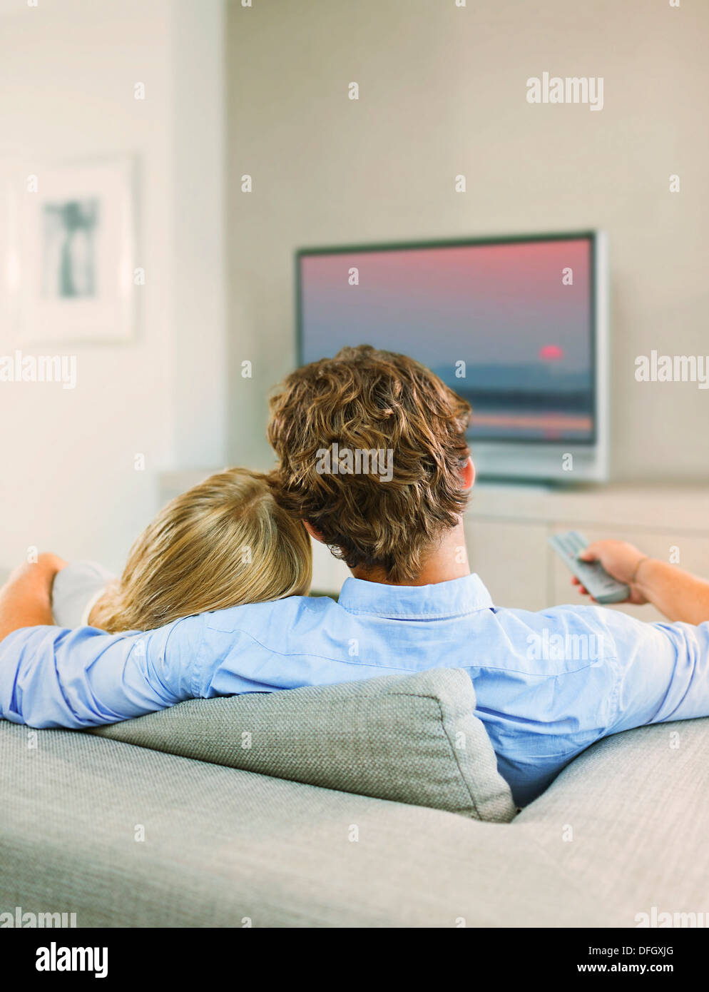 Couple watching television on sofa Stock Photo Alamy