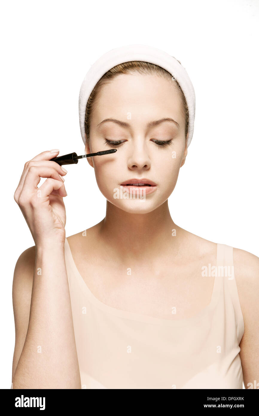 Woman applying mascara Stock Photo