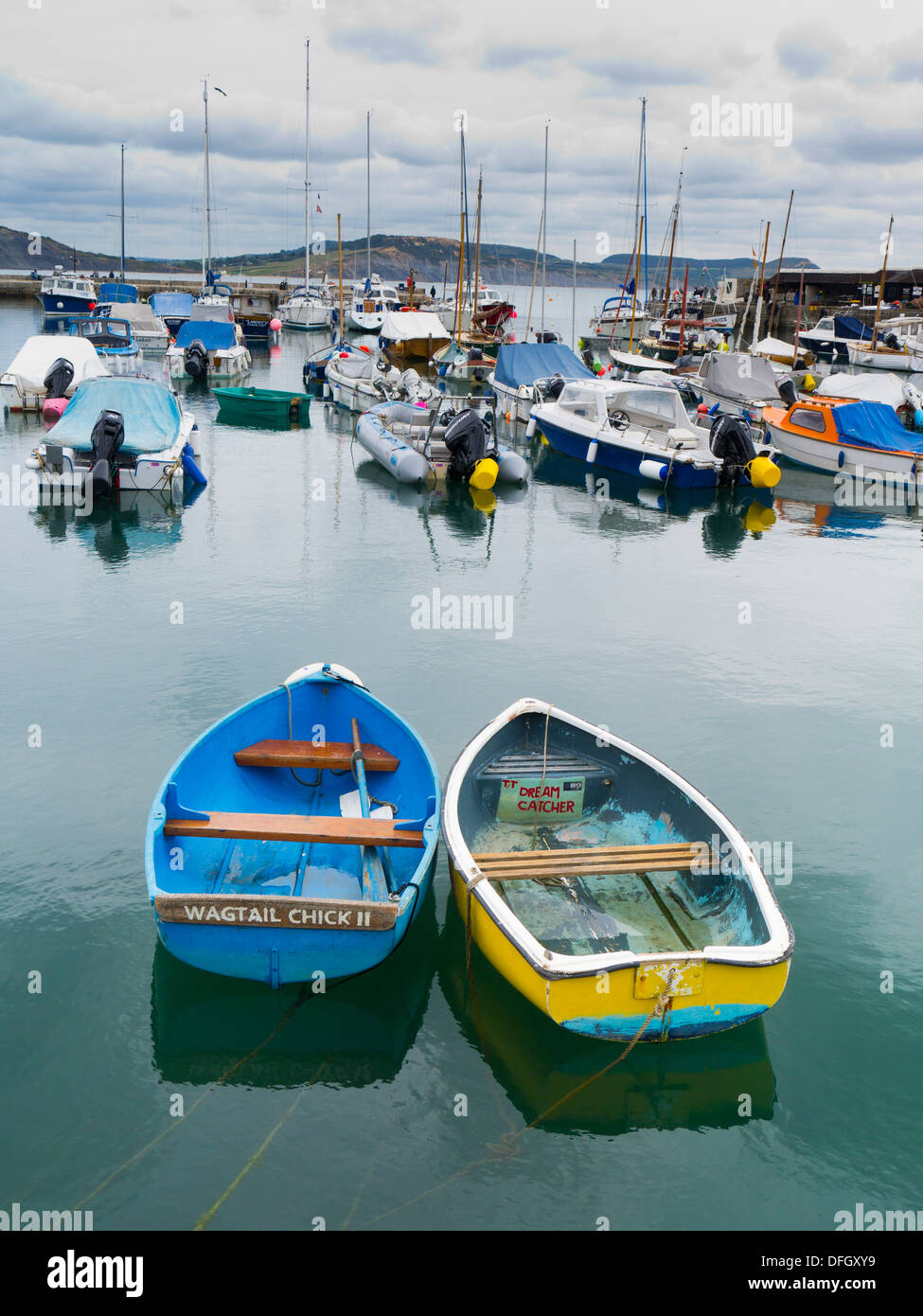Two rowing boats moored in Lyme Regis harbour Dorset England UK Stock Photo