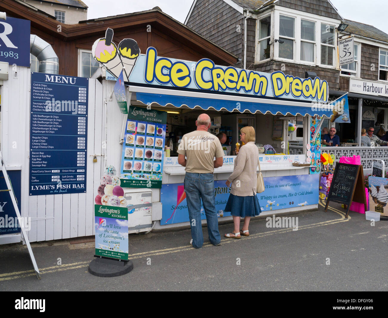 Customers buying ice cream at kiosk in Lyme Regis Dorset England Stock Photo