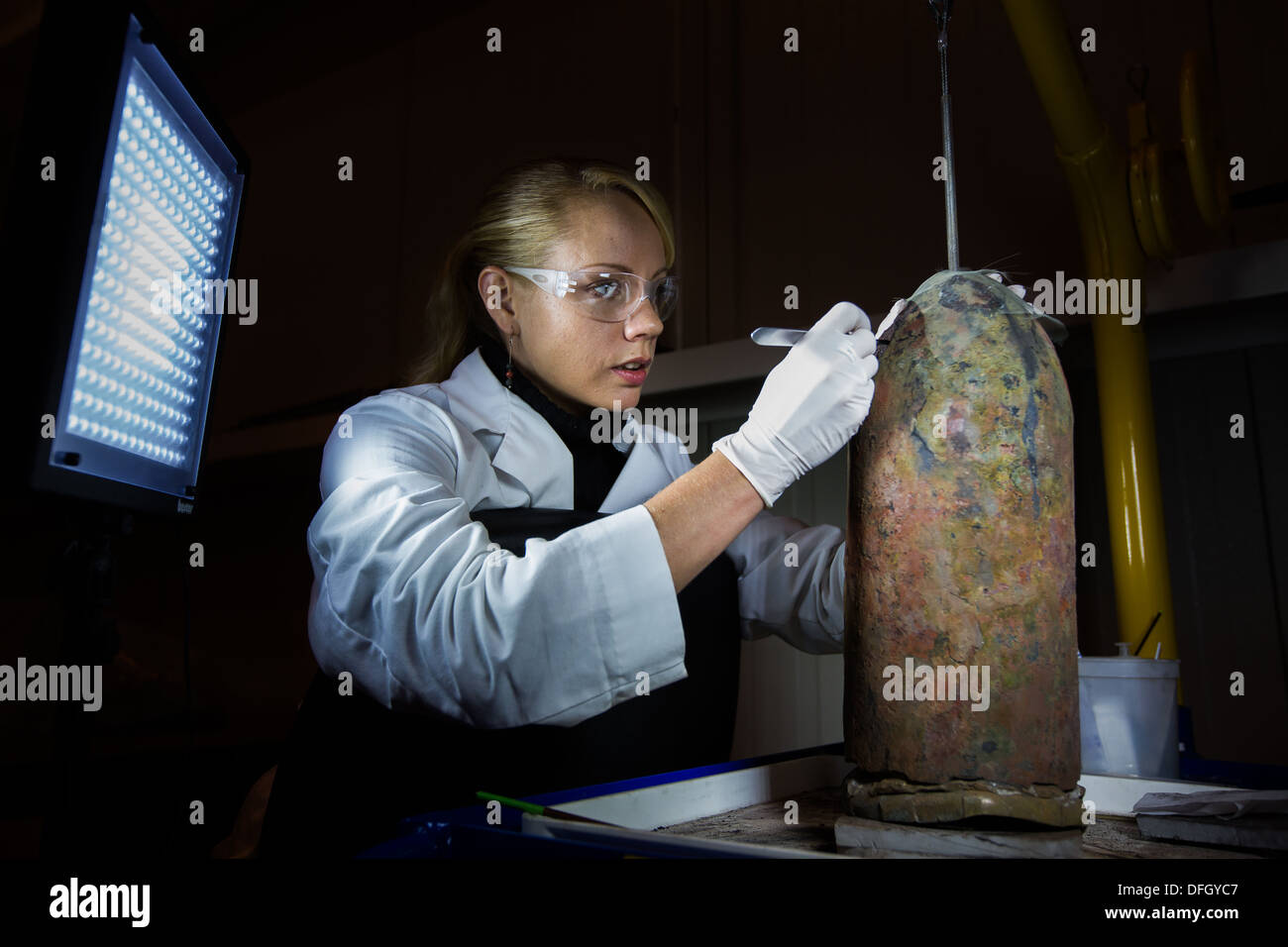 Scientist works on a bomb shell from the Civil War era in the Hunley Lab in North Charleston, SC. Stock Photo