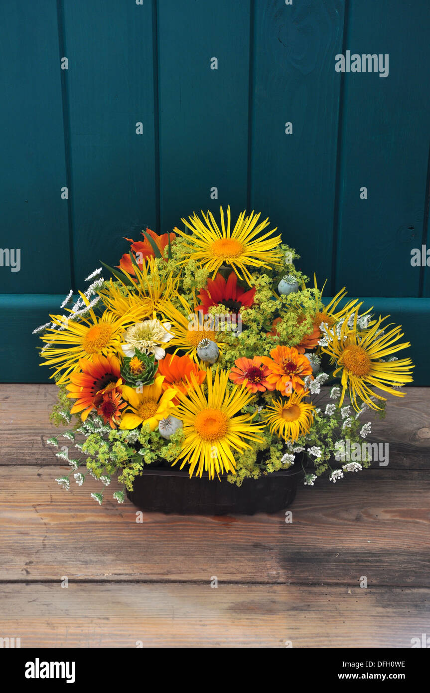 A yellow and orange pretty cut flower display UK Stock Photo