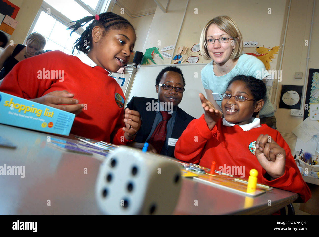 teachers with children playing board game at primary school Stock Photo