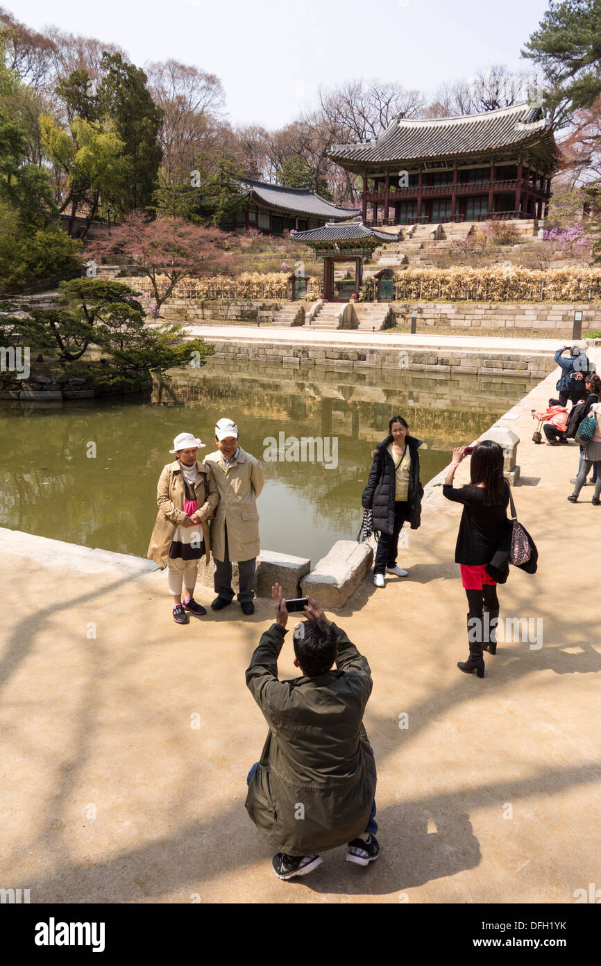 Tourist taking photographs in the garden of Changdeokgung Royal Palace  in Seoul, Korea Stock Photo