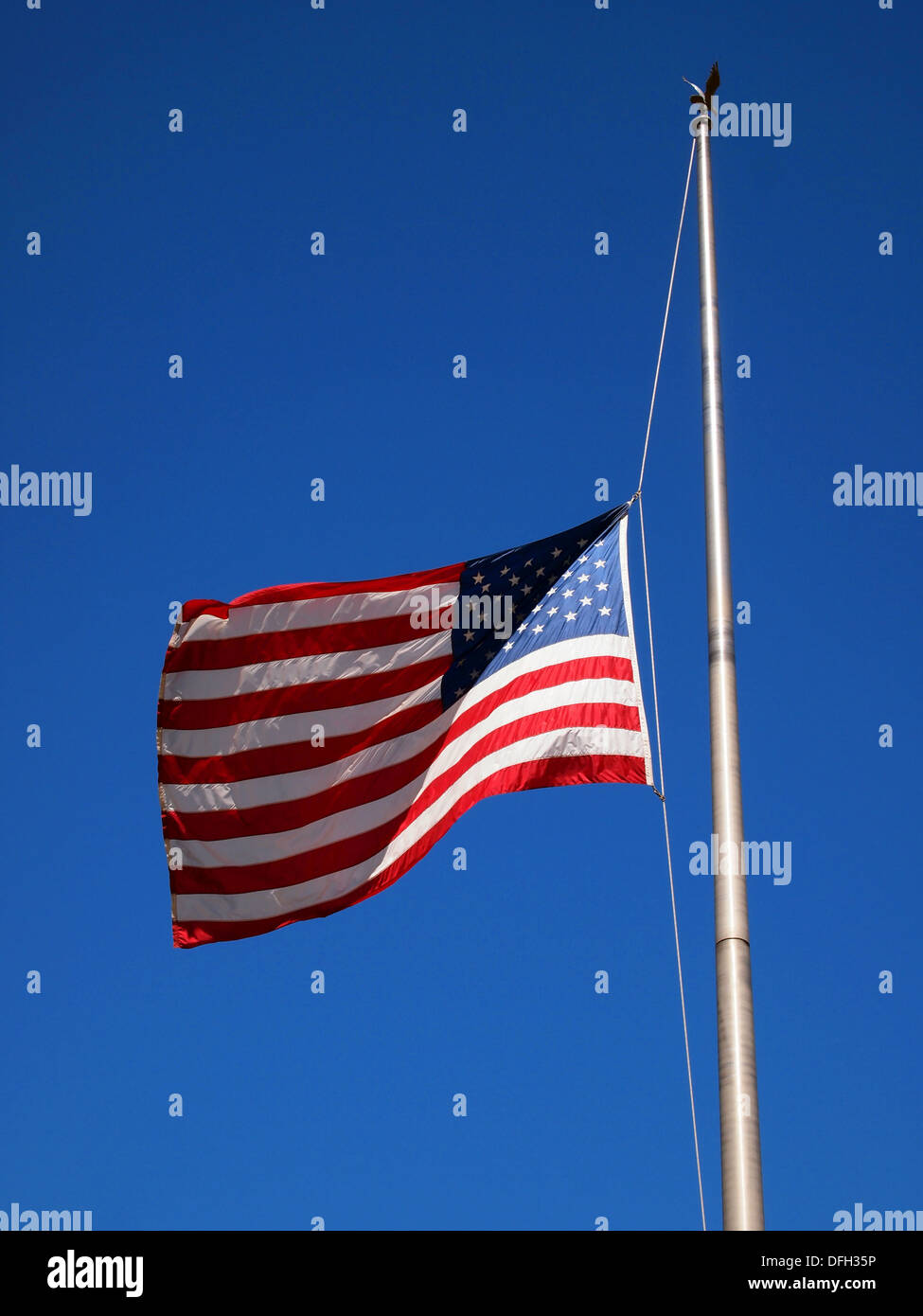 American flag at half mast. Stock Photo