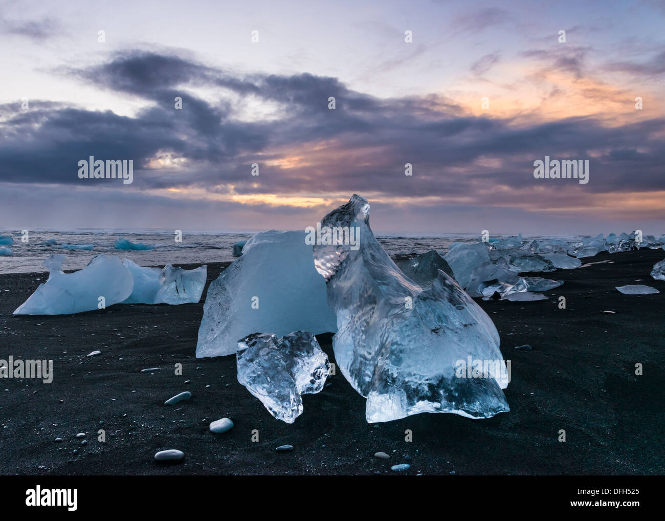 Crystal clear ice melts on the black sandy beach at Jokulsarlon, Iceland Stock Photo