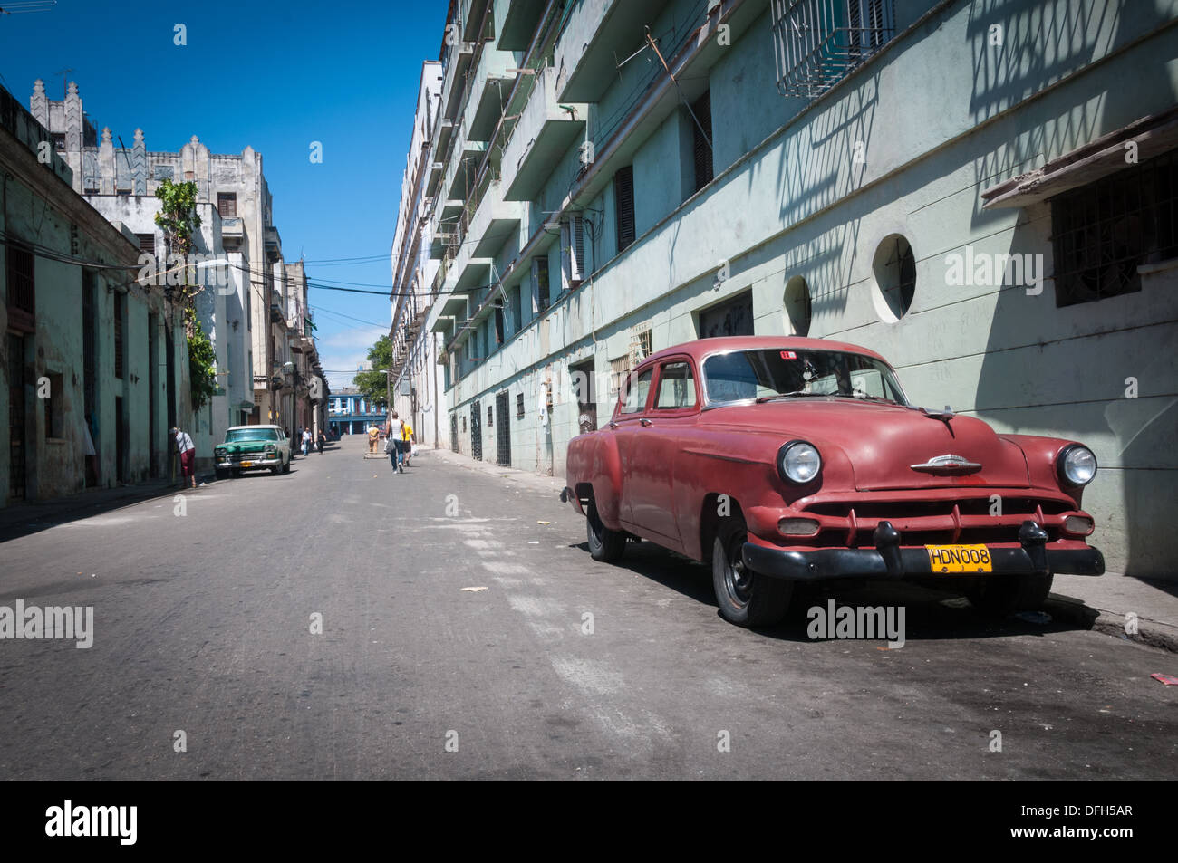 A classic American car is parked down a dusty side street in the Cuban capitol of Havana Stock Photo