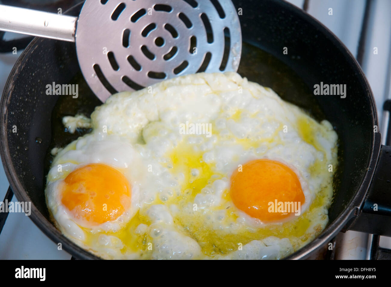 Frying two eggs in olive oil. Close view Stock Photo Alamy