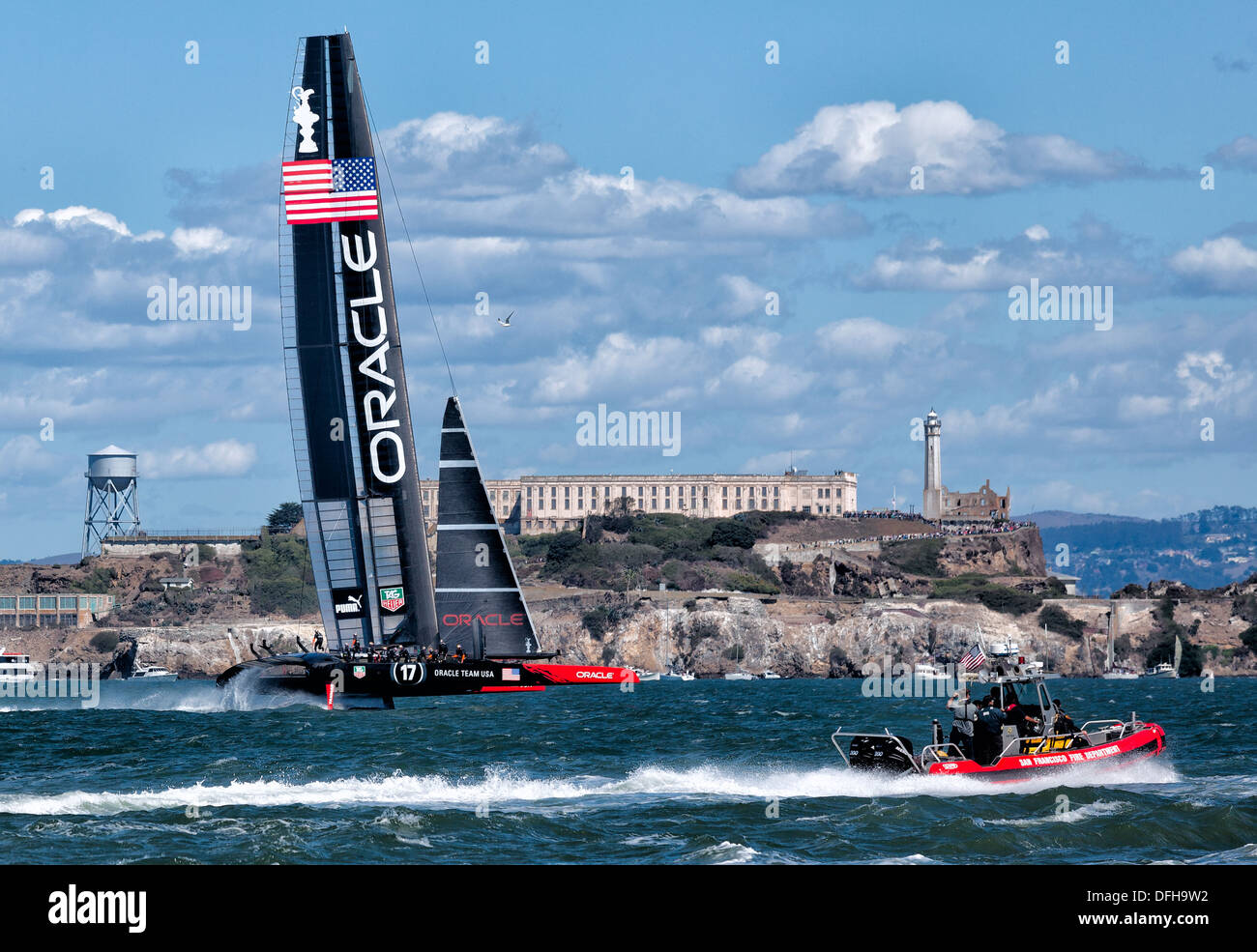 SAN FRANCISCO-SEPT 25, 2013: Oracle Team USA approaches Alcatraz Island during the final race of America's Cup with New Zealand Stock Photo