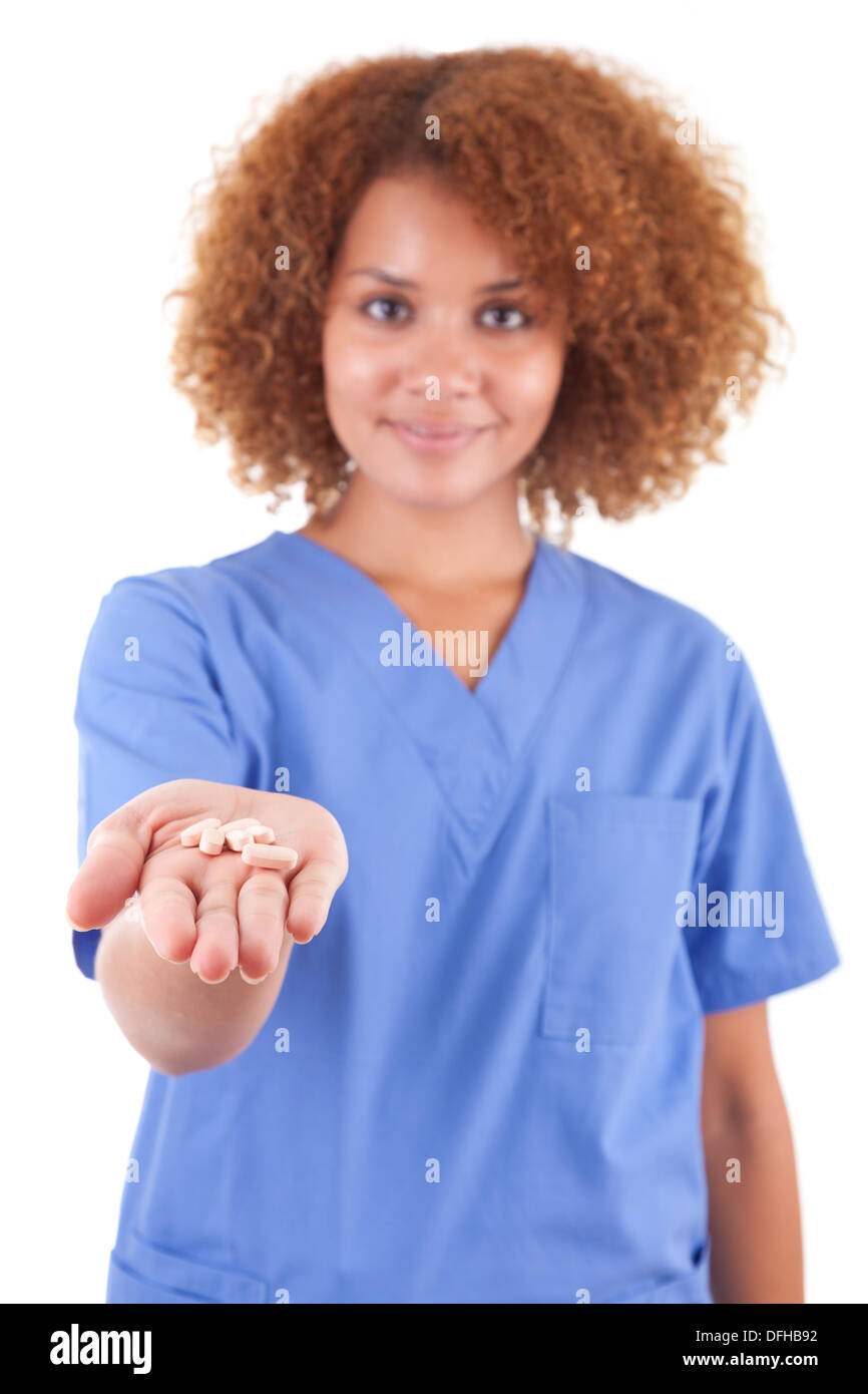 African American nurse holding pills, isolated on white background - Black people Stock Photo