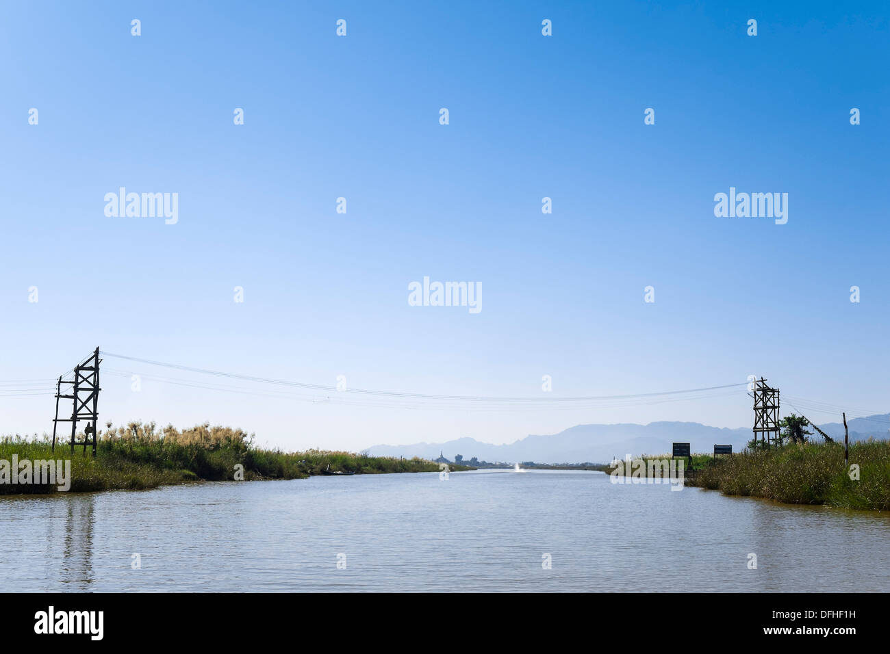Power line across a canal at Inle Lake, Myanmar, Asia Stock Photo