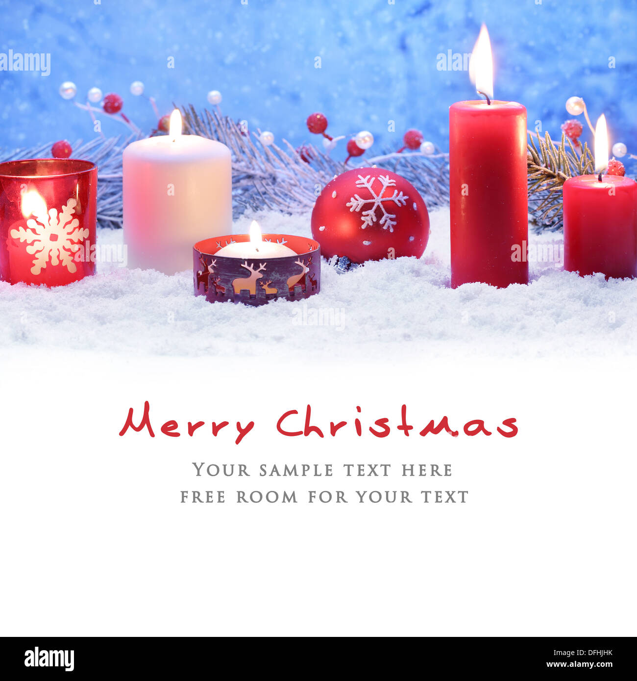 Christmas decoration with candles and ball on snow. Stock Photo