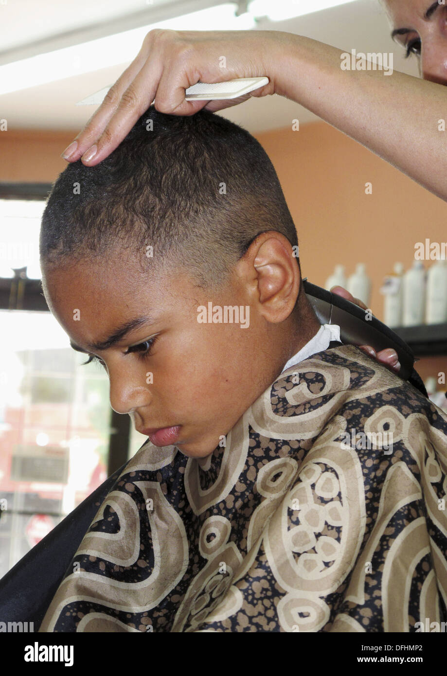 6 year old African American boy getting a hair cut Making a face Stock  Photo - Alamy