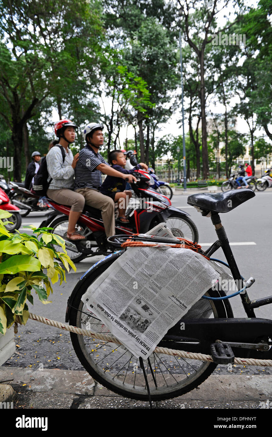 Family group riding on a motorbike or moped on a busy road in Ho Chi Minh city. Stock Photo