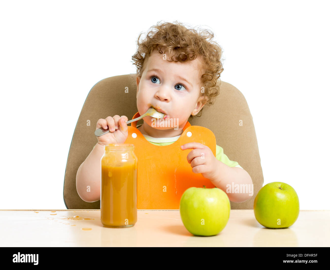 baby eating sauce by himself Stock Photo