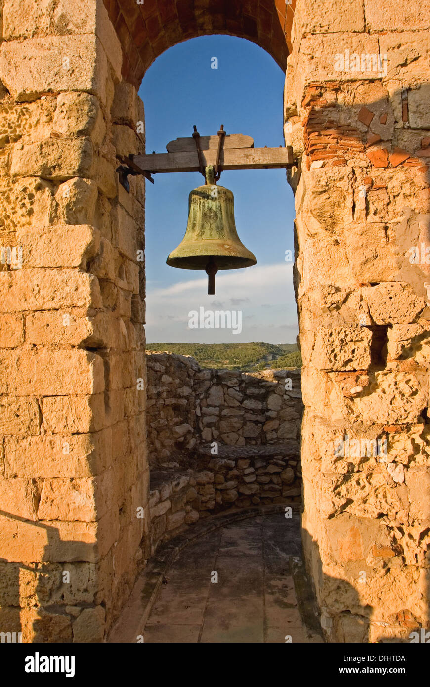 Old bell tower and bell hanging in the medieval castle Santa Creu, in Calafell, Spain. Stock Photo