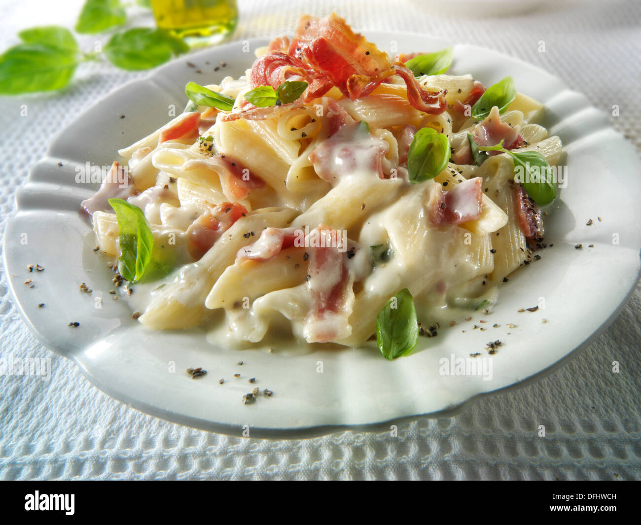 Penne pasta carbonara with a cheese sauce and crispy bacon Stock Photo -  Alamy
