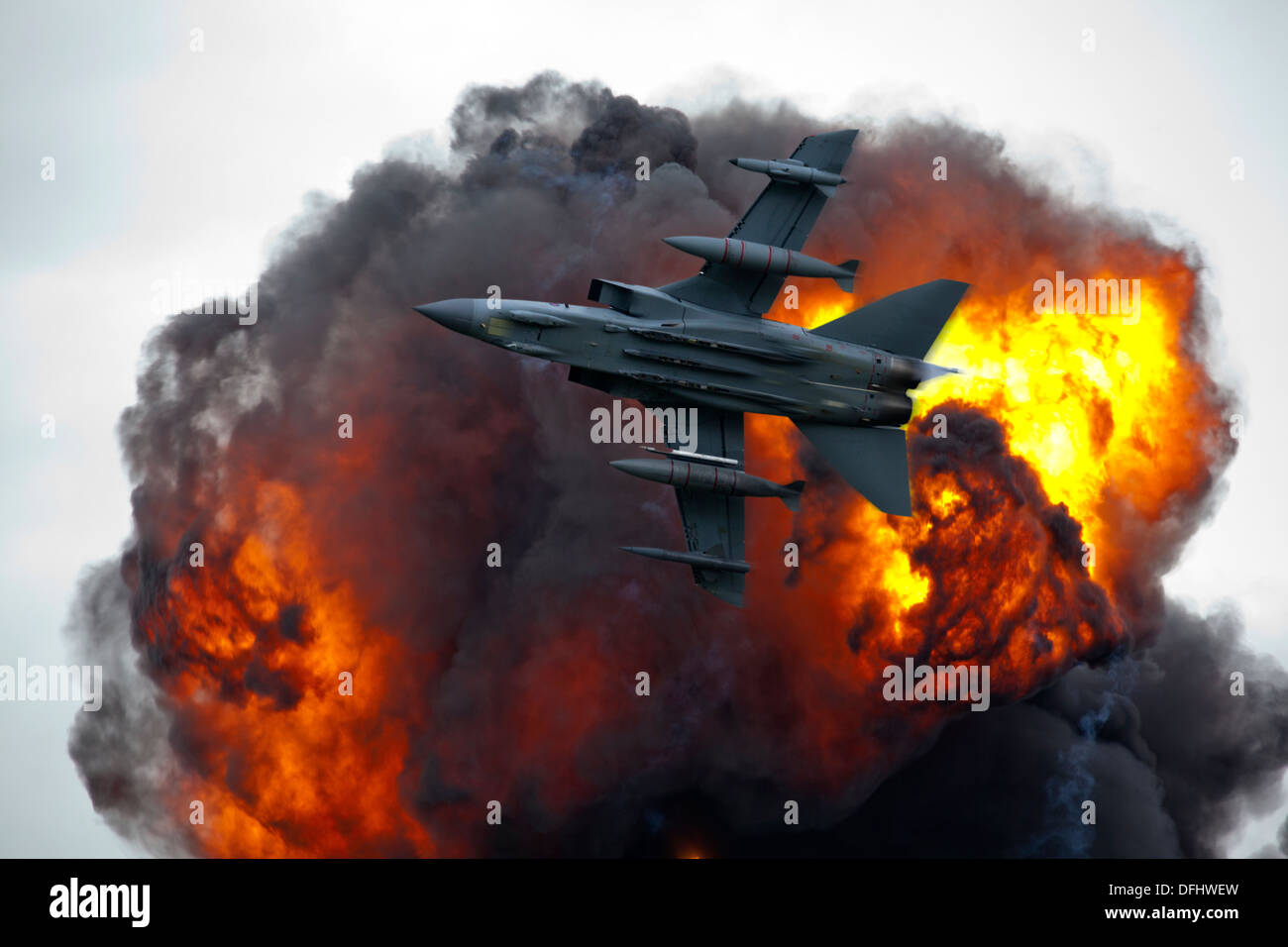 Jet fighter bomber in flight with explosion blast Stock Photo