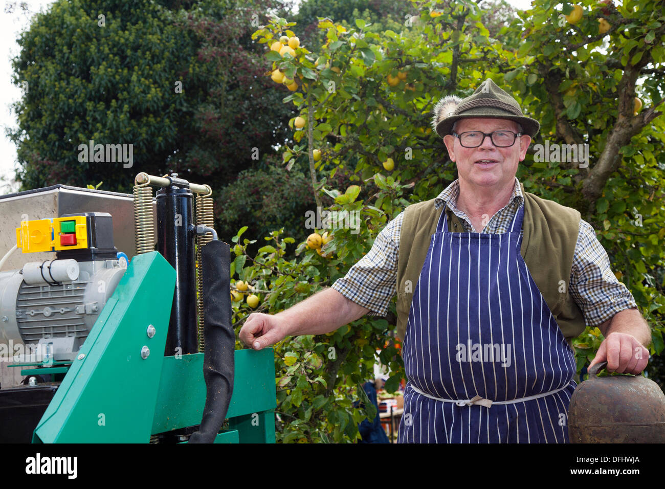 Arnside, Silverdale, UK. 5th October, 2013. Mr Edi Albert pressing apples with a Kerbl Austrian fruit press at Arnside's fifth  AONB Apple Day at Briery Bank Orchard, Arnside. Lots of apples and pumpkins on sale,  wildlife displays, apple identification experts puzzling over rare varieties and lots of freshly pressed juice - the apple press worked hard all day to satisfy the thirst of almost 1000 visitors. Stock Photo