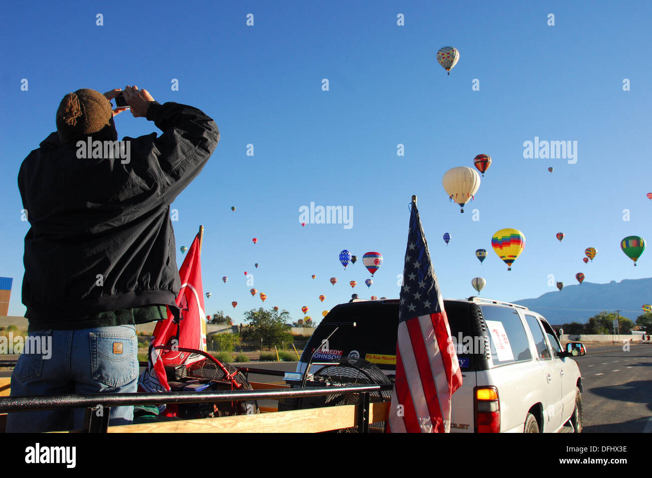 Albuquerque, New Mexico, USA. 05th Oct, 2013. Travis Clark a member of the Chase Crew of the balloon The Final Frontier our of Kansas City, Missouri, takes pictures of the hundreds of balloons at the Albuquerque International Balloon Fiesta on Saturday, Oct. 5, 2013. Clark and the rest of the Chase Crew were waitng for their balloon to land. Credit:  Brian Winter/Alamy Live News Stock Photo